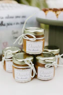 Small jars of caramel candy tied with white ribbon