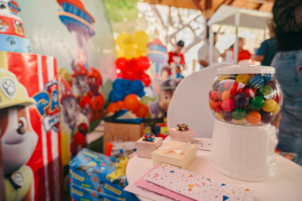 Birthday party decorations with gumball machine and cakes