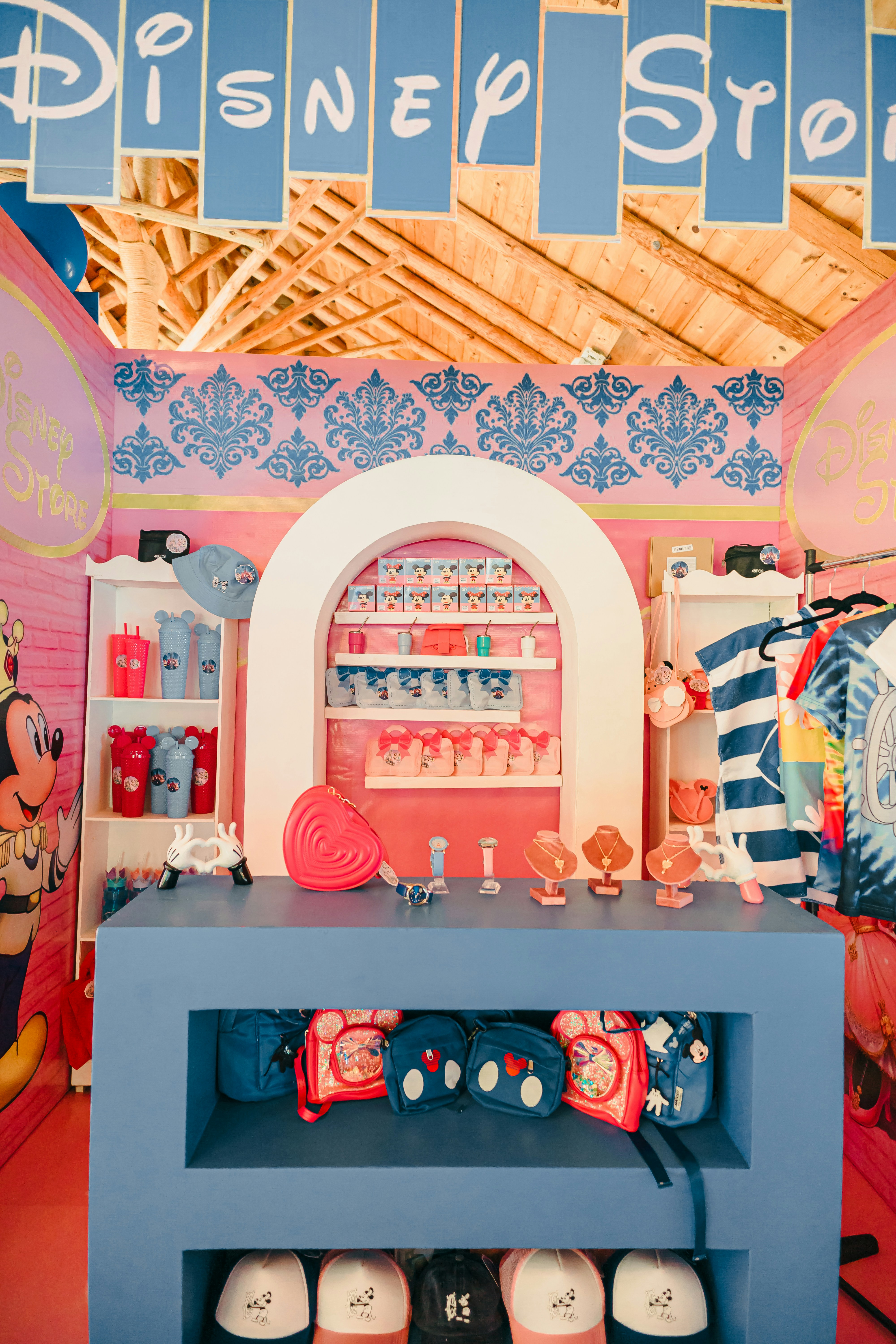 Disney store merchandise displayed on shelves and racks.