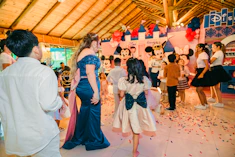 Children in disney costumes at a party with confetti.