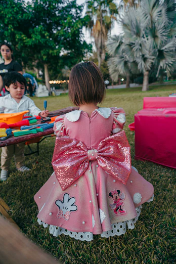 Young girl in a pink dress with large bow
