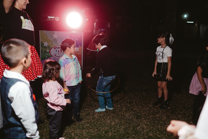 Kids in costumes playing games together at an evening community Halloween event, similar to the carnival games at Monster Mash and Movie Bash