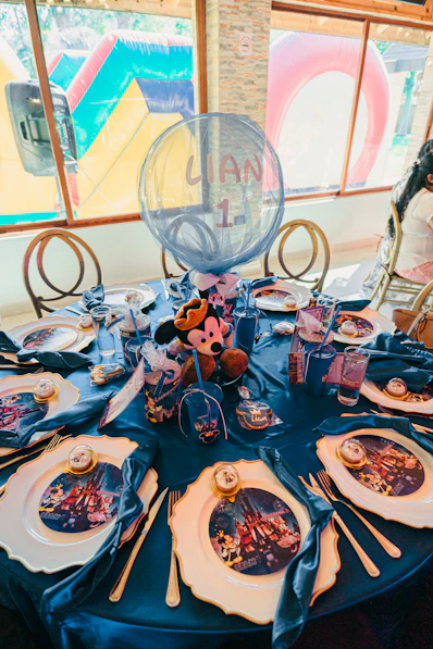 A disney-themed birthday party table setting with mickey mouse decorations