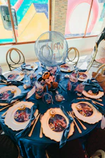 A mickey mouse themed table setting with a large balloon.