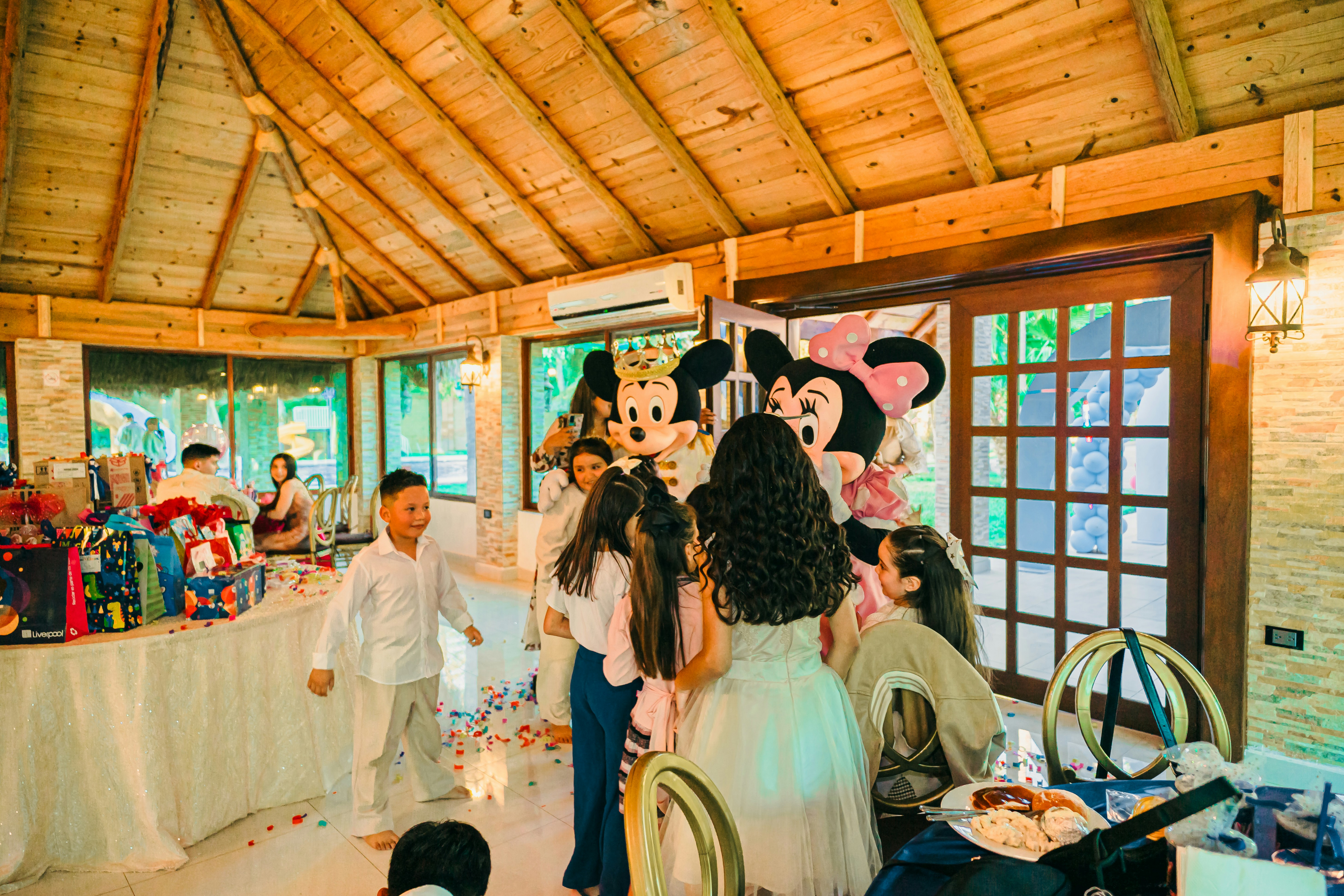Children gathered around minnie and mickey mouse characters