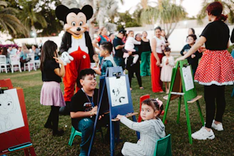Mickey mouse character at a children's outdoor art party.