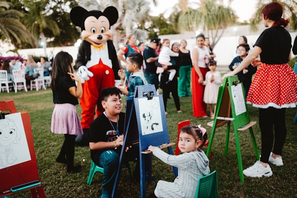 Mickey mouse character at a children's outdoor art party.