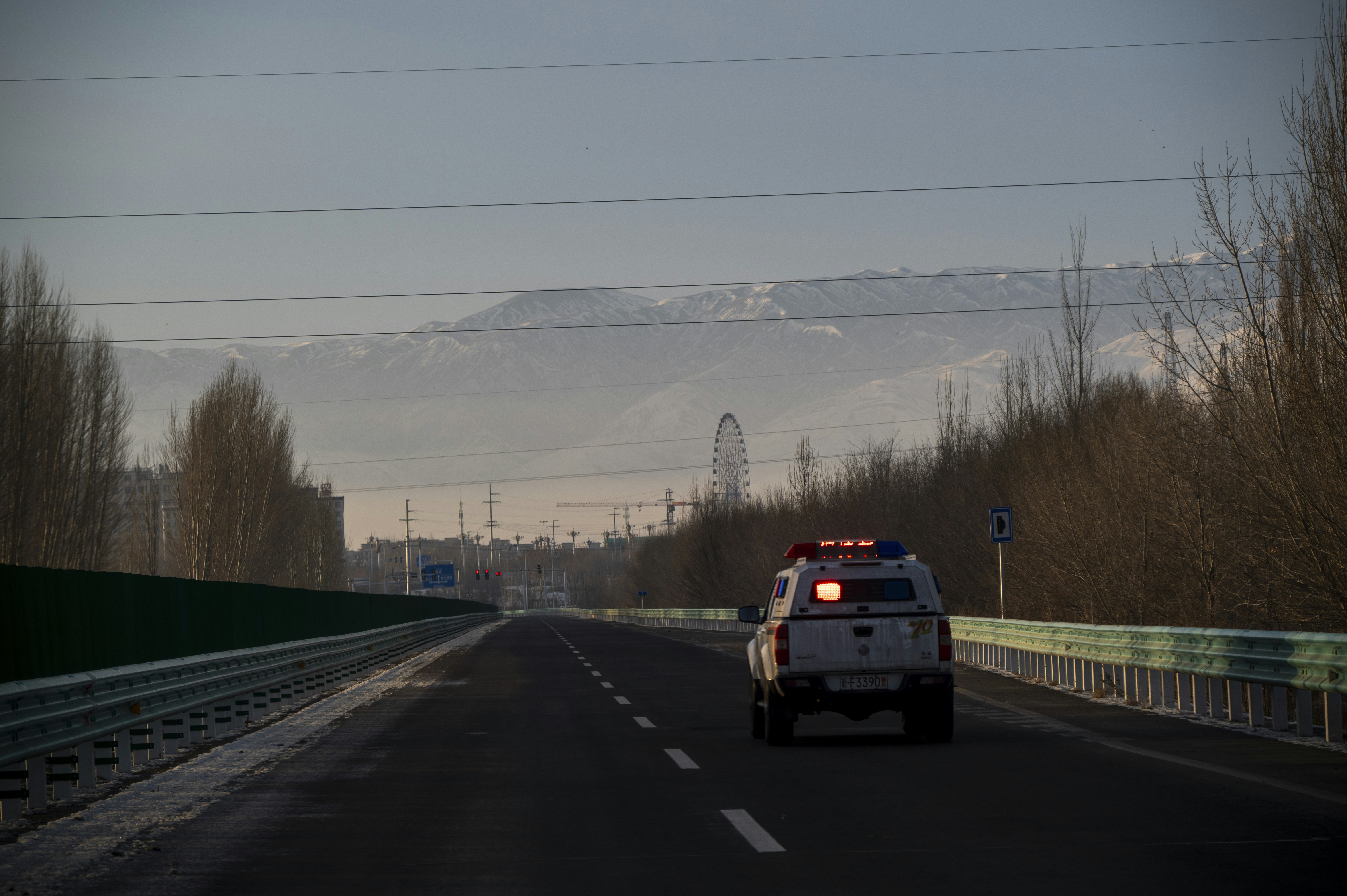 Police car driving on highway towards mountains