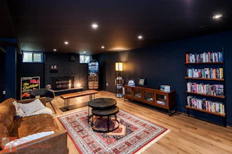 Cozy living room with fireplace and bookshelves.