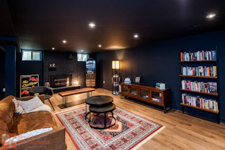 Cozy living room with fireplace and bookshelves.