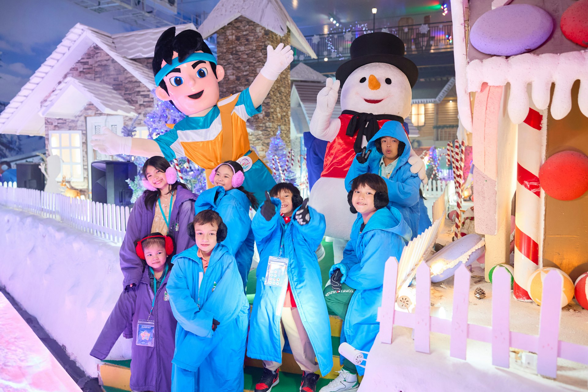 People in winter coats with snowman and cartoon characters