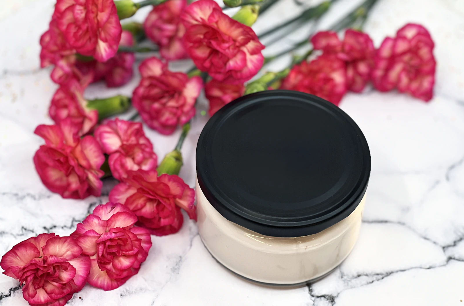 A jar of everyday face moisturiser on a marble surface, representing an affordable moisturiser comparison