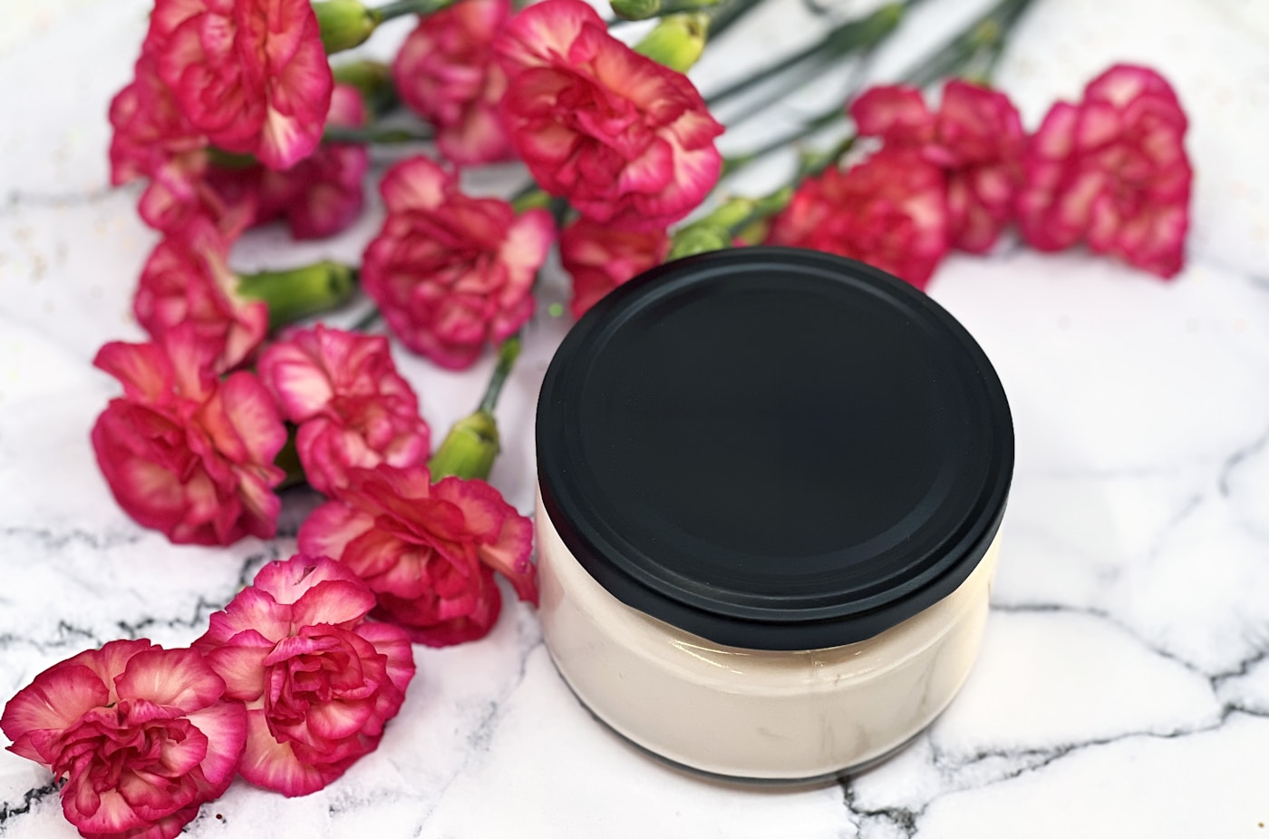 Rose Quartz Eye Cream open jar on warm wood