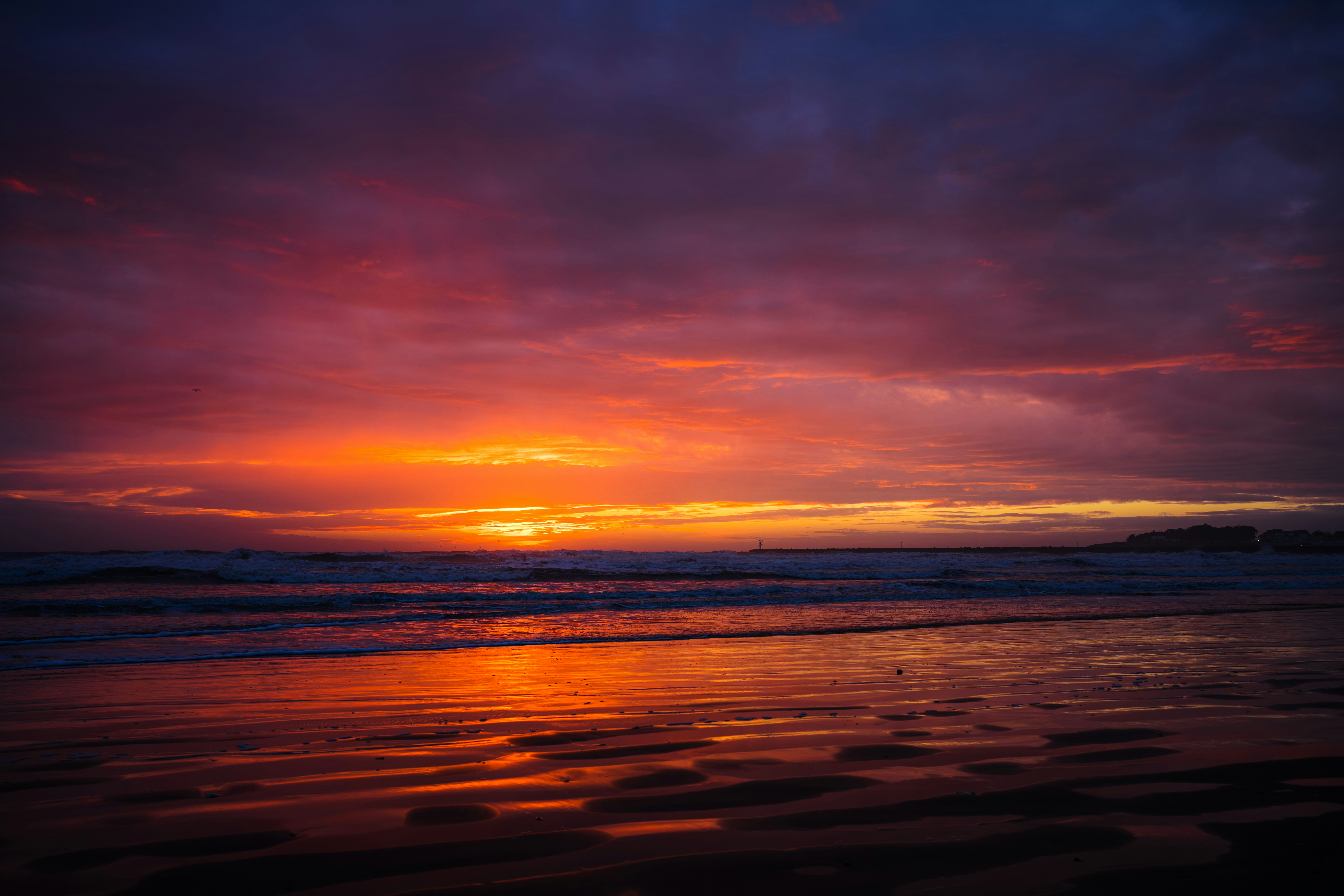 Vibrant sunset over the ocean with colorful clouds.