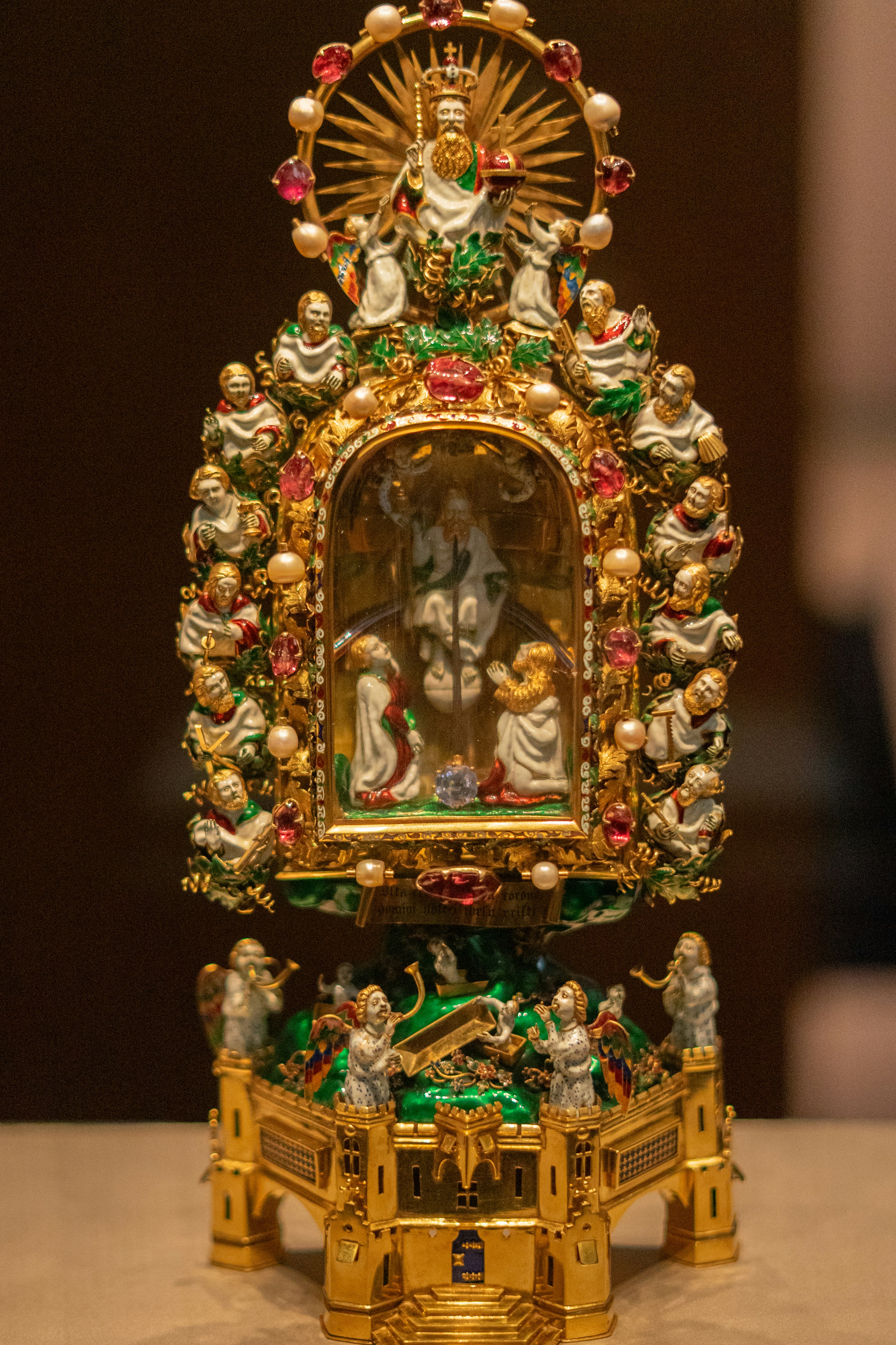 Ornate golden reliquary with religious figures and jewels.