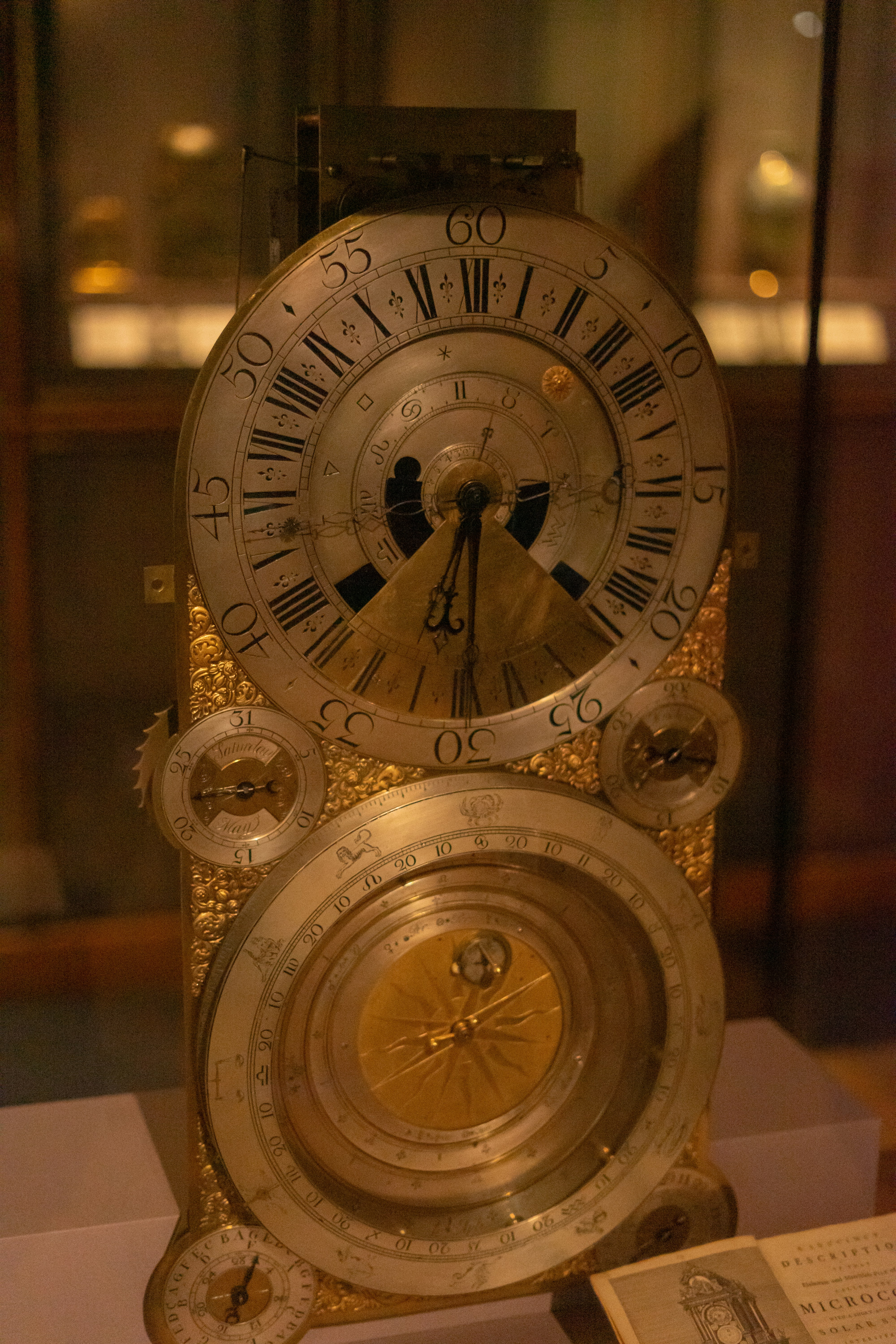 Antique astronomical clock with intricate golden details.
