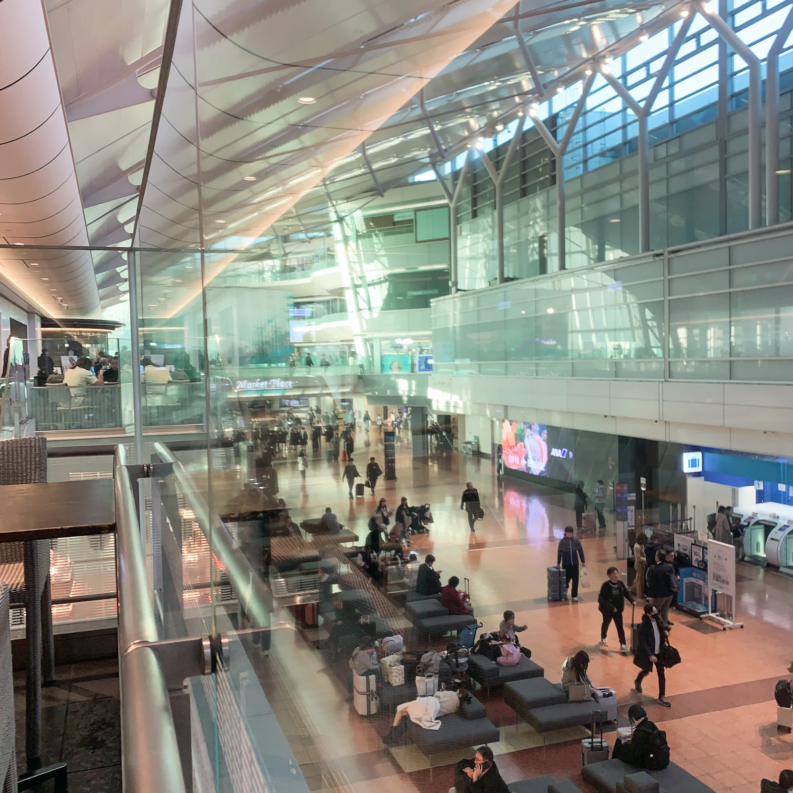 Travelers waiting and walking in a busy airport terminal