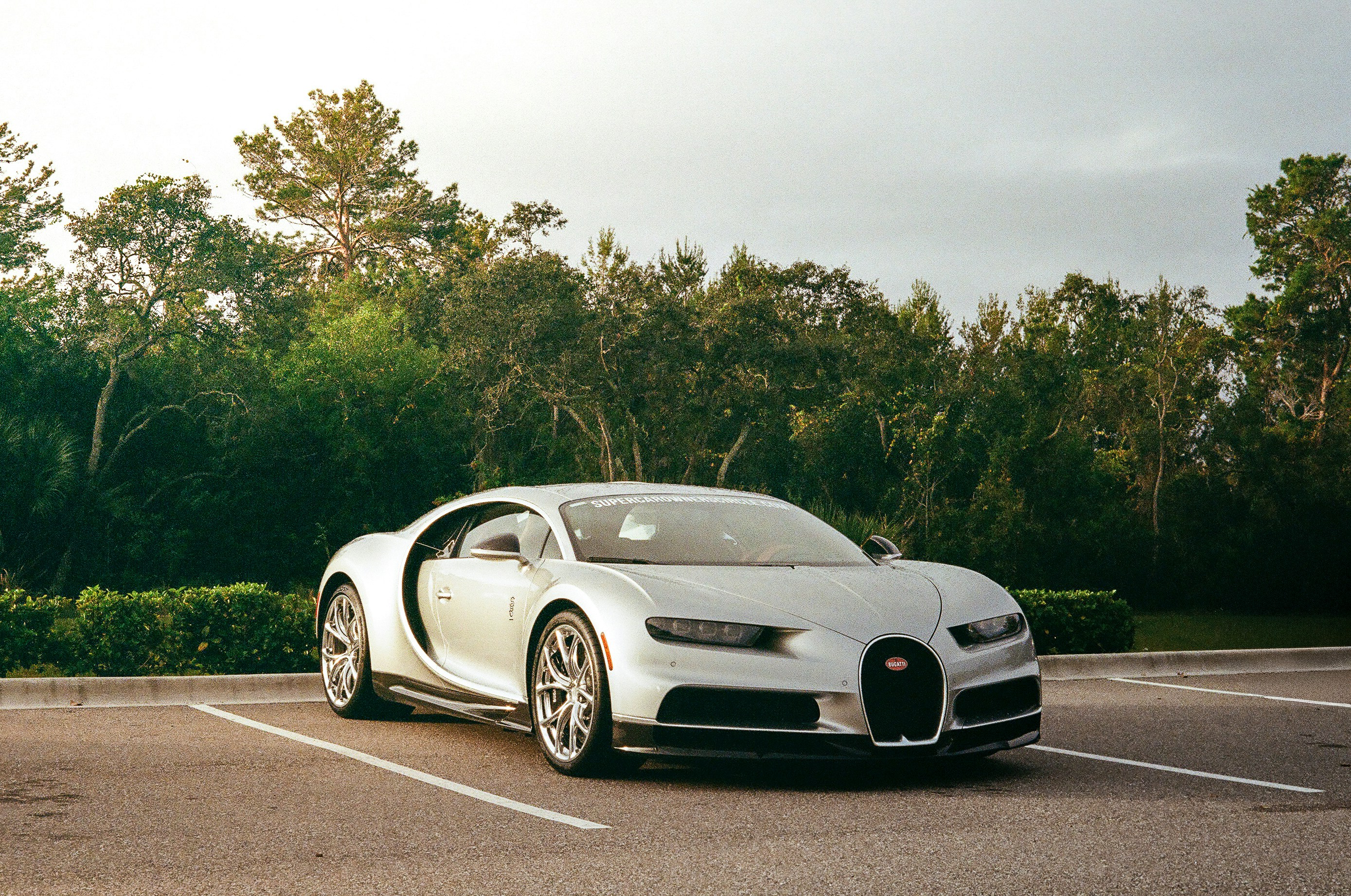 Silver luxury sports car parked in a lot