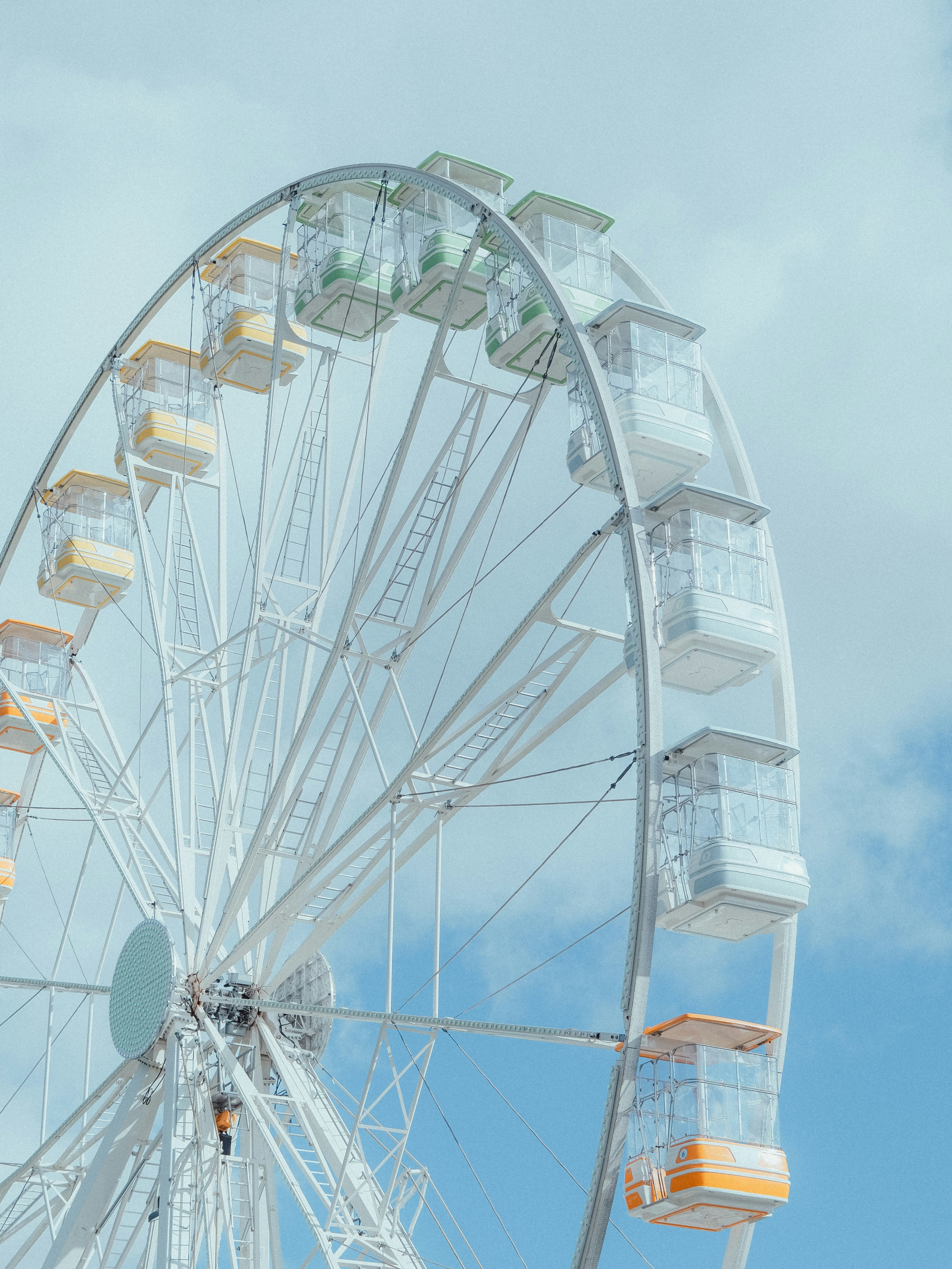 Ein weißes Riesenrad vor blauem Himmel.