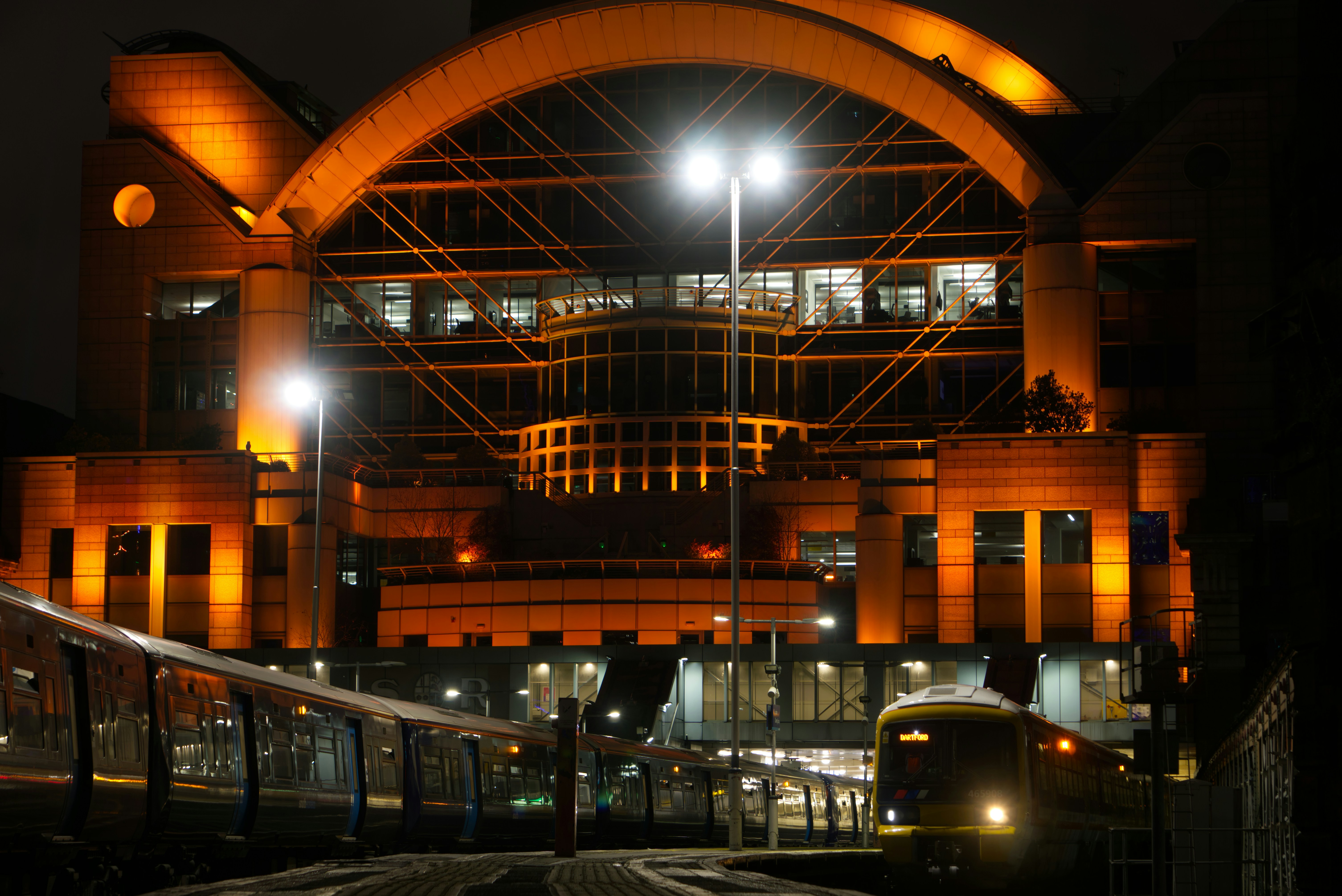 Train station illuminated at night with archway structure