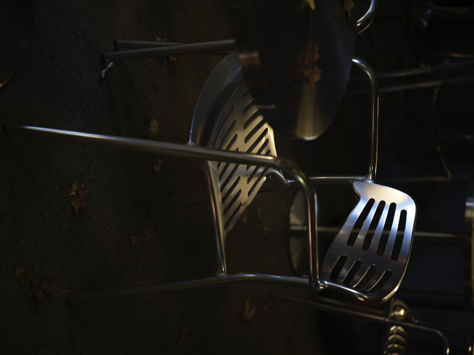 Real stainless steel kitchen utensils arranged in a professional culinary setting