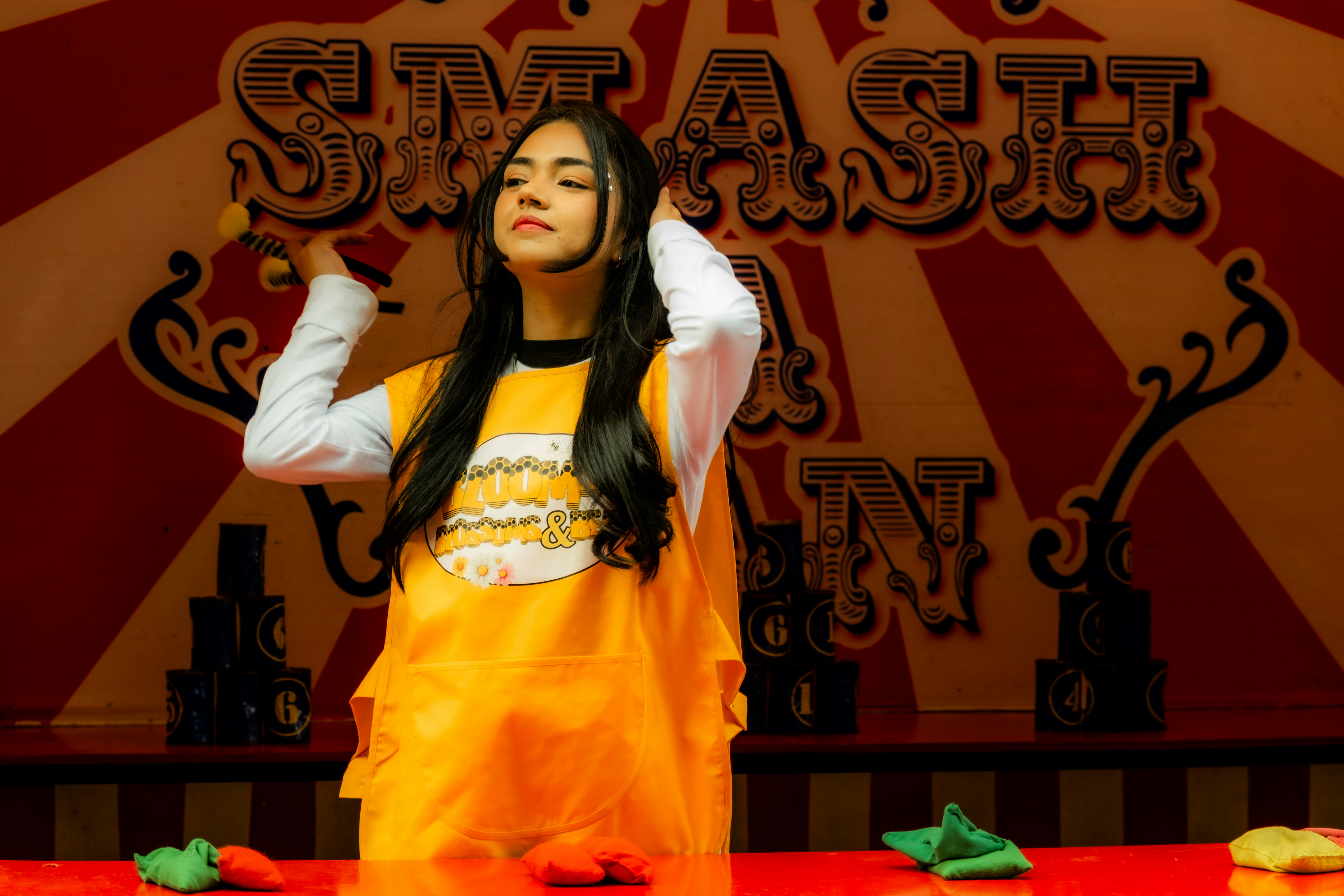 Young woman playing carnival game with balls