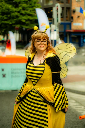 Woman in a bee costume with wings and antennae