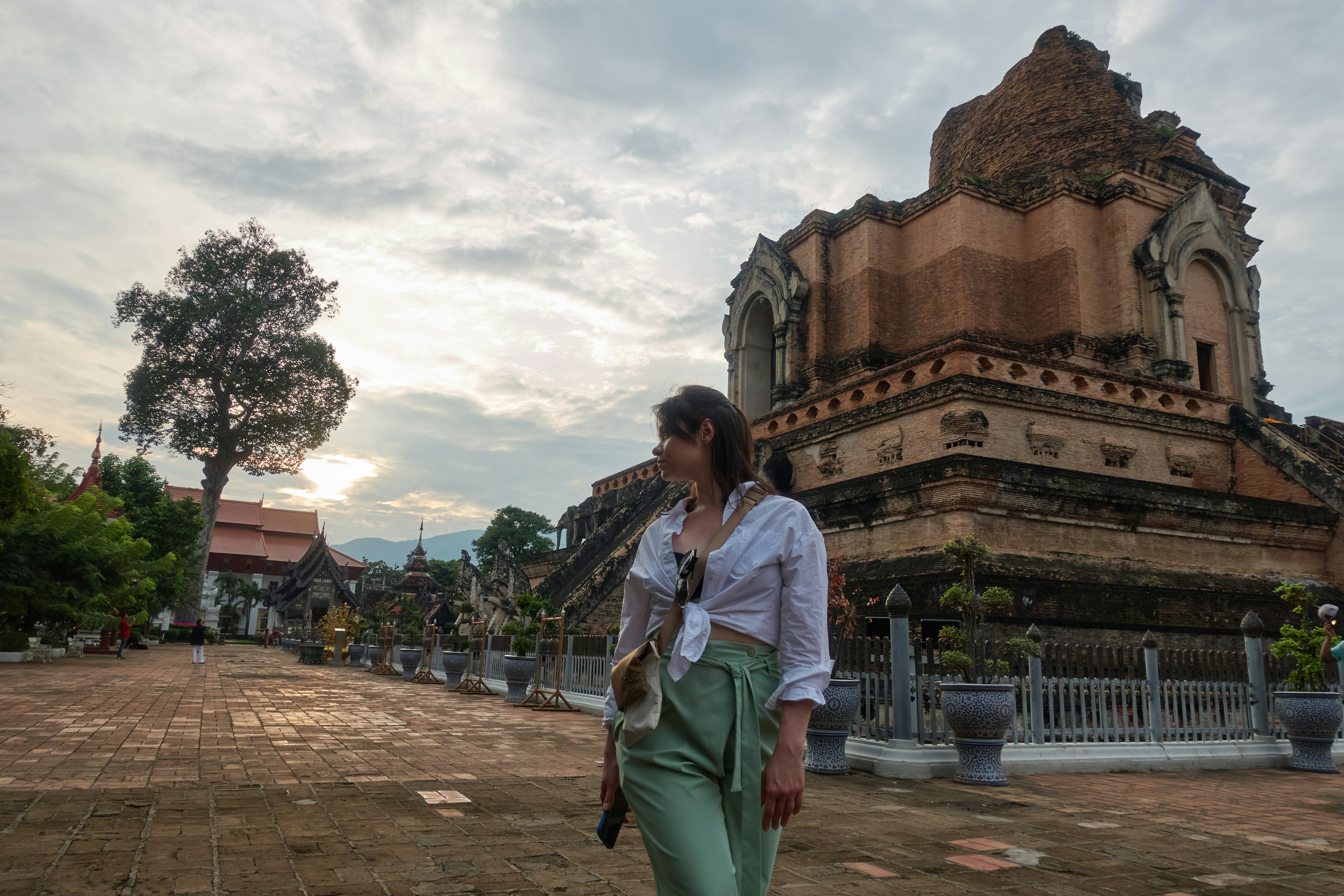 Woman walking near ancient brick temple ruins