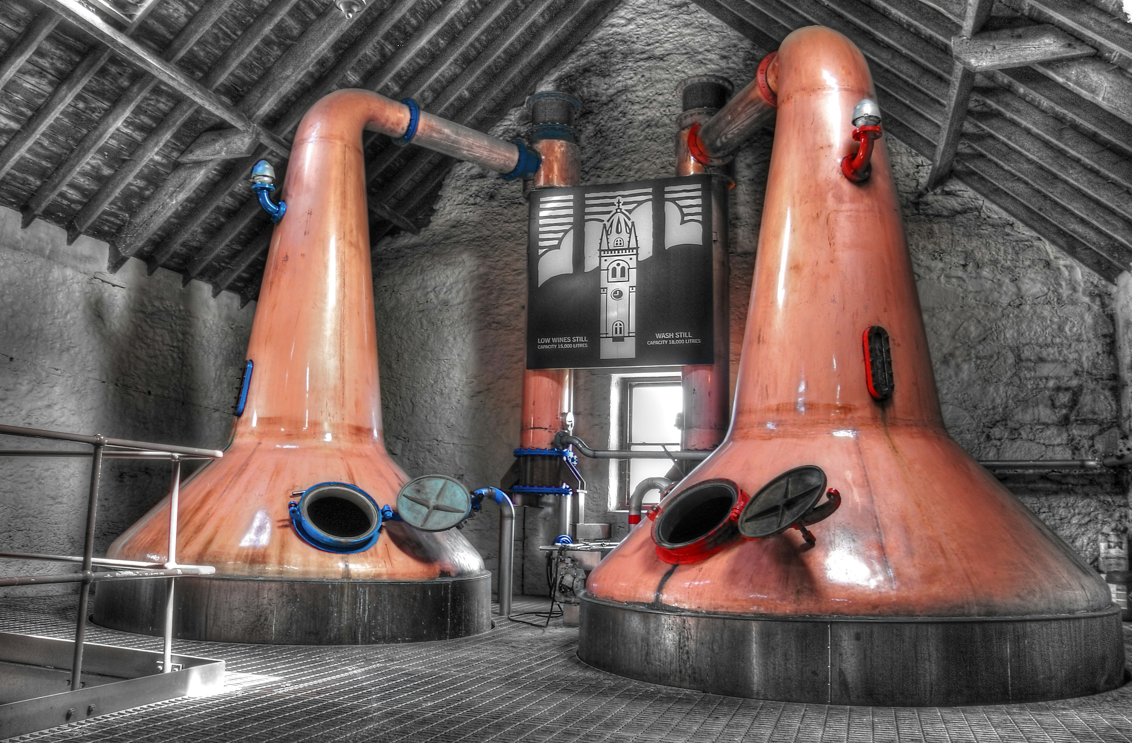 Two copper stills in a distillery