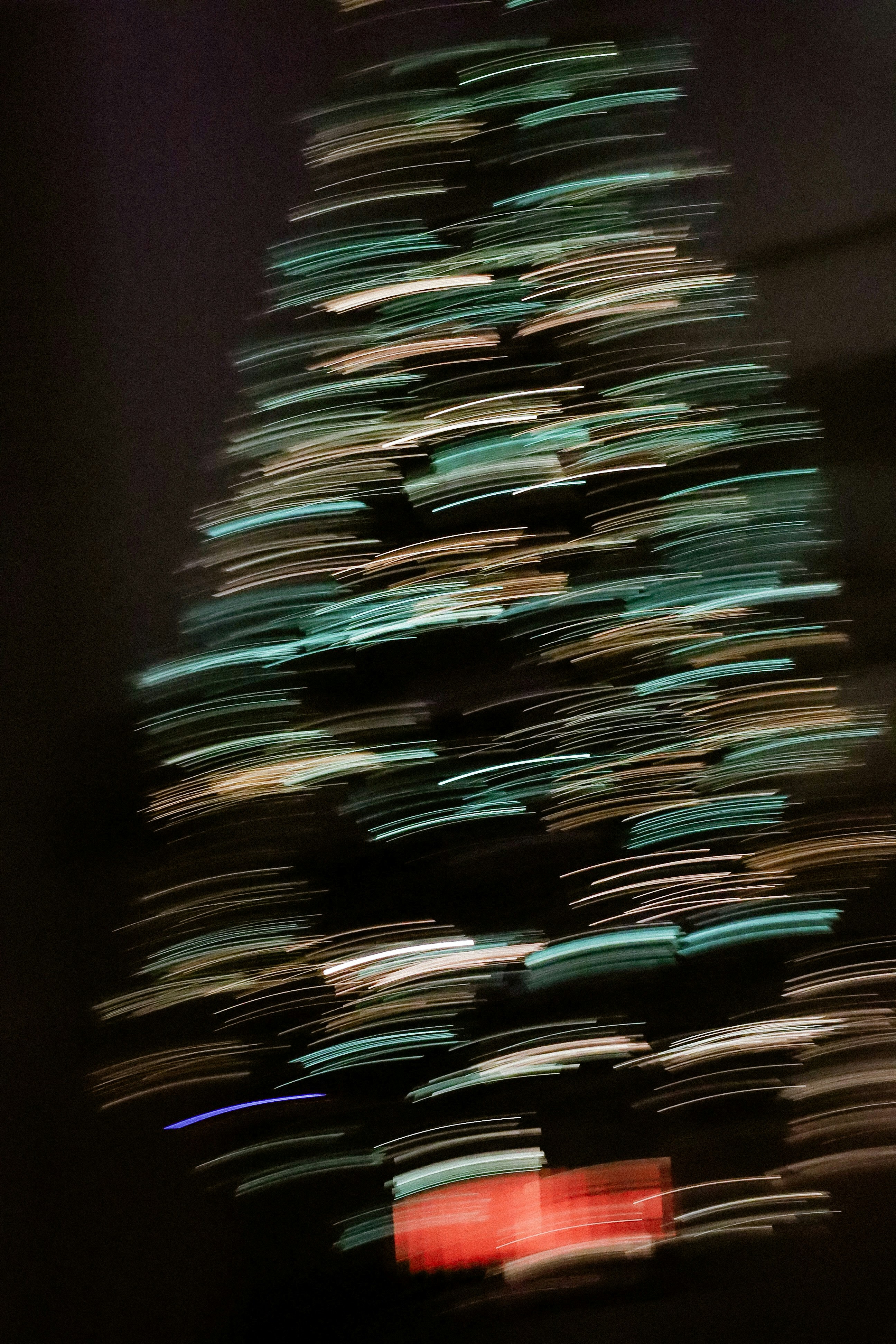 Abstract blurred christmas tree lights with red gift box