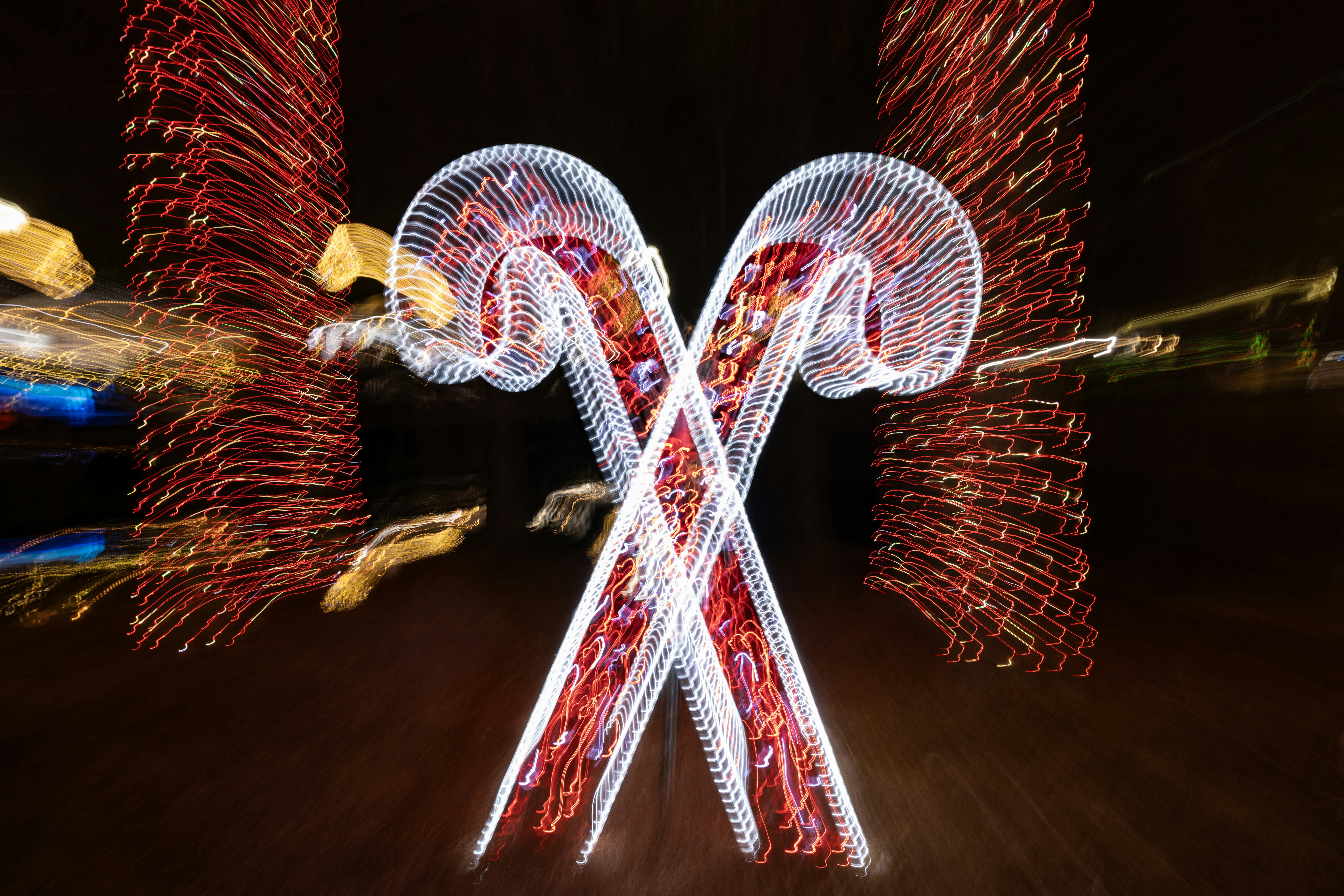 Two illuminated candy canes with red lights