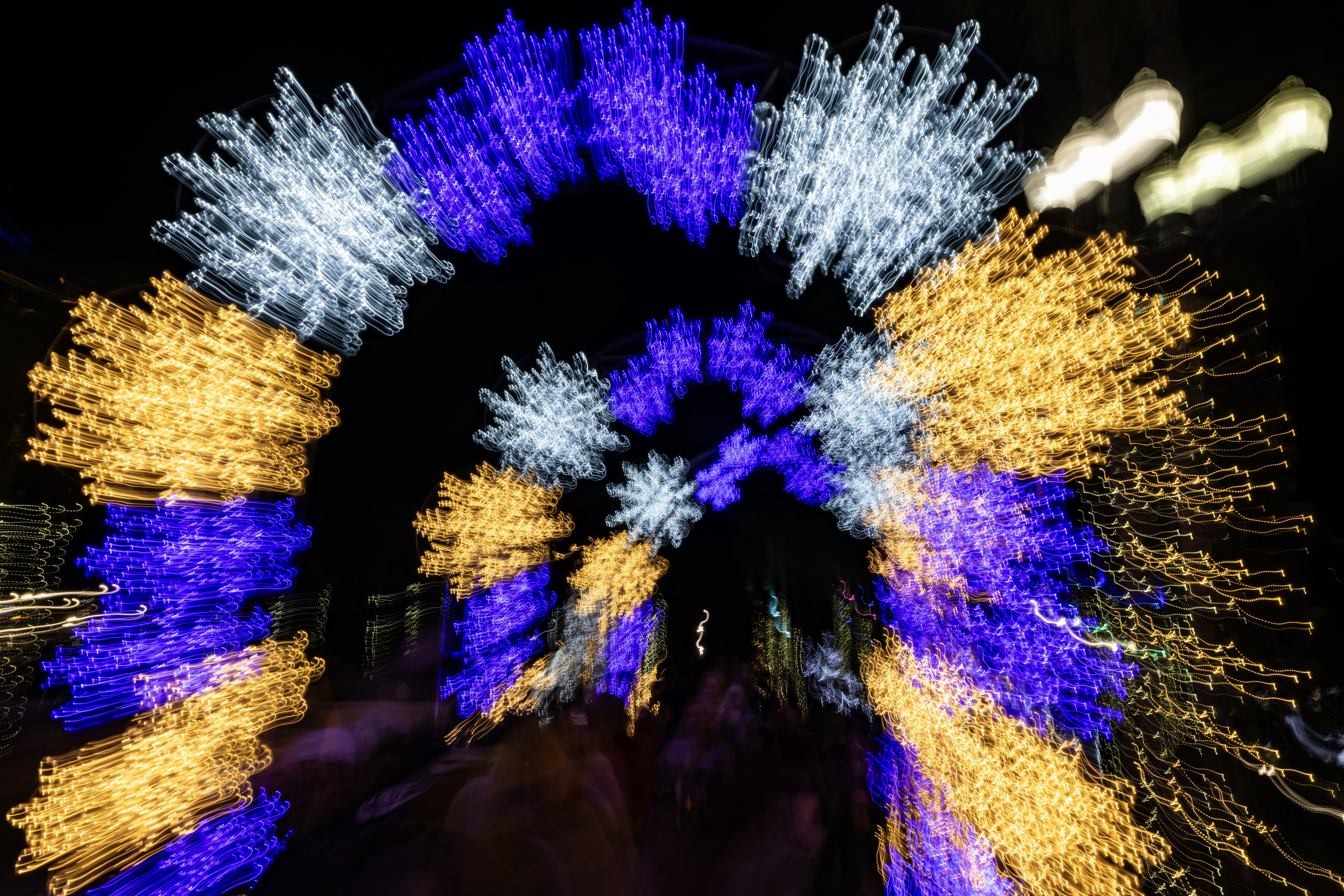 Blurry festive lights in archway at night