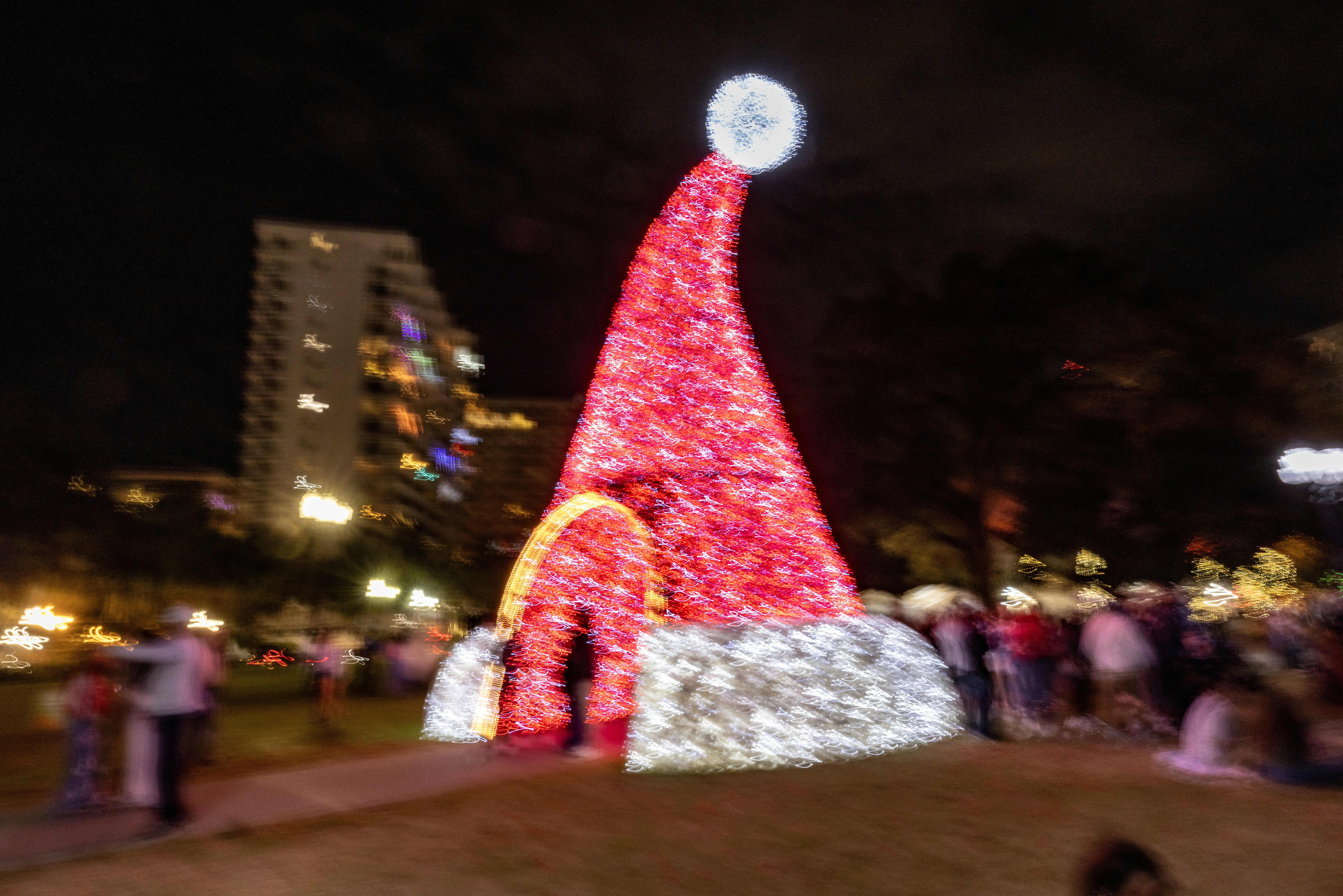 Giant illuminated santa hat decoration at night