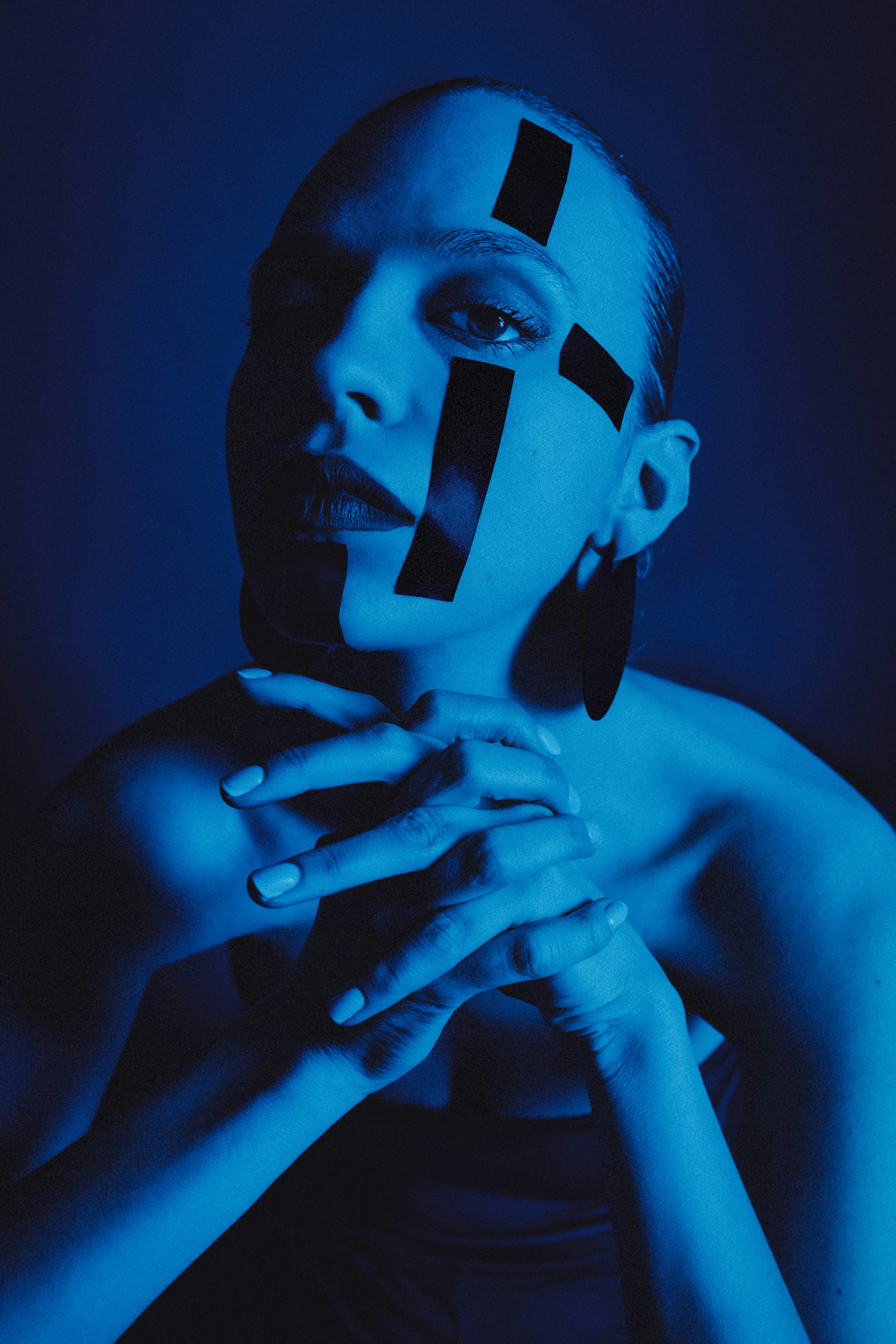 Woman with black tape on her face