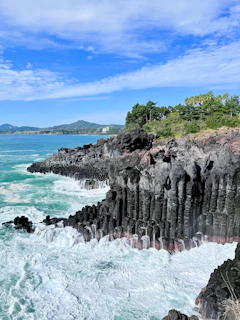 Waves crashing against dark volcanic rock formations