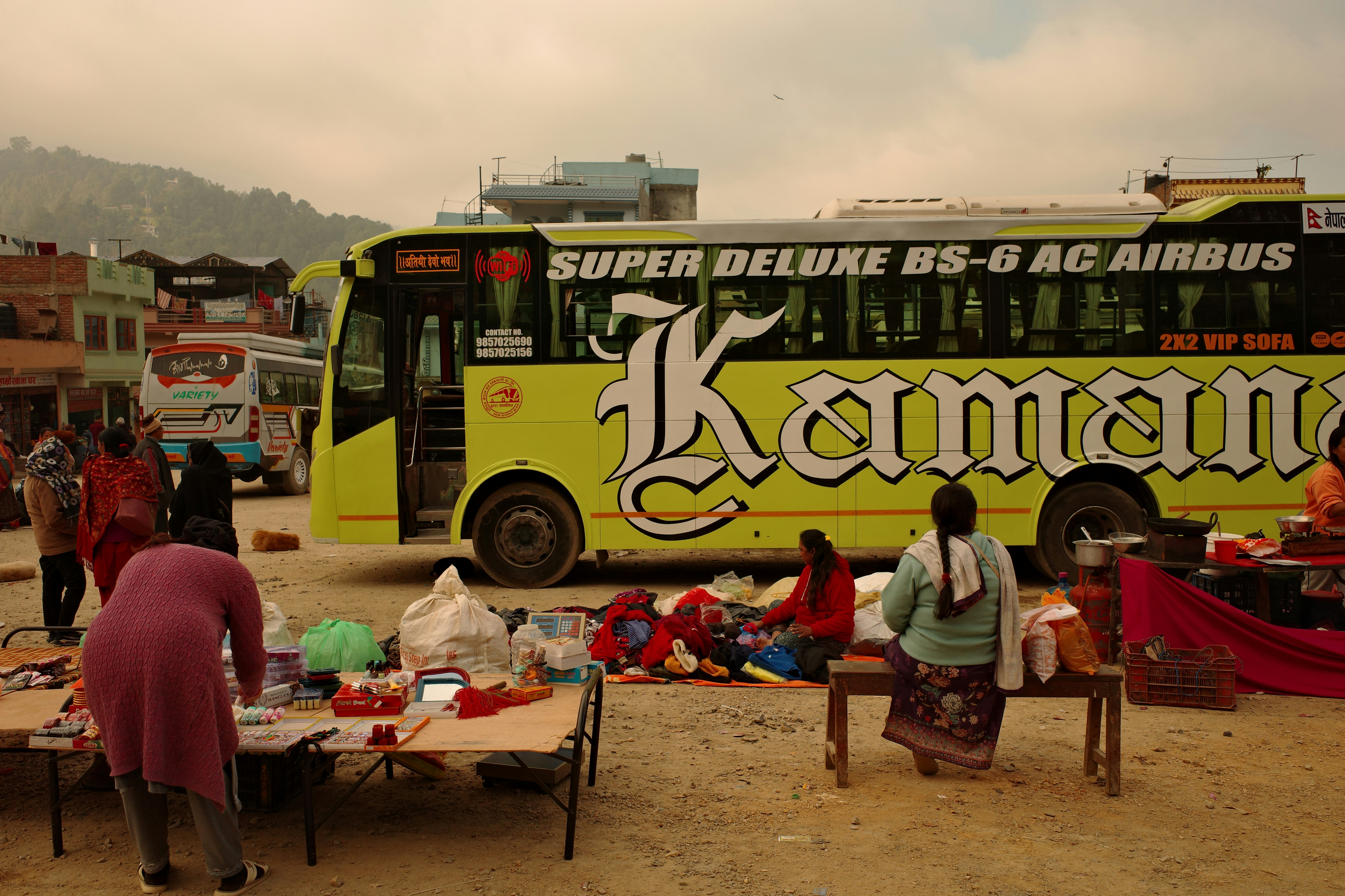 Yellow bus parked at a busy outdoor market