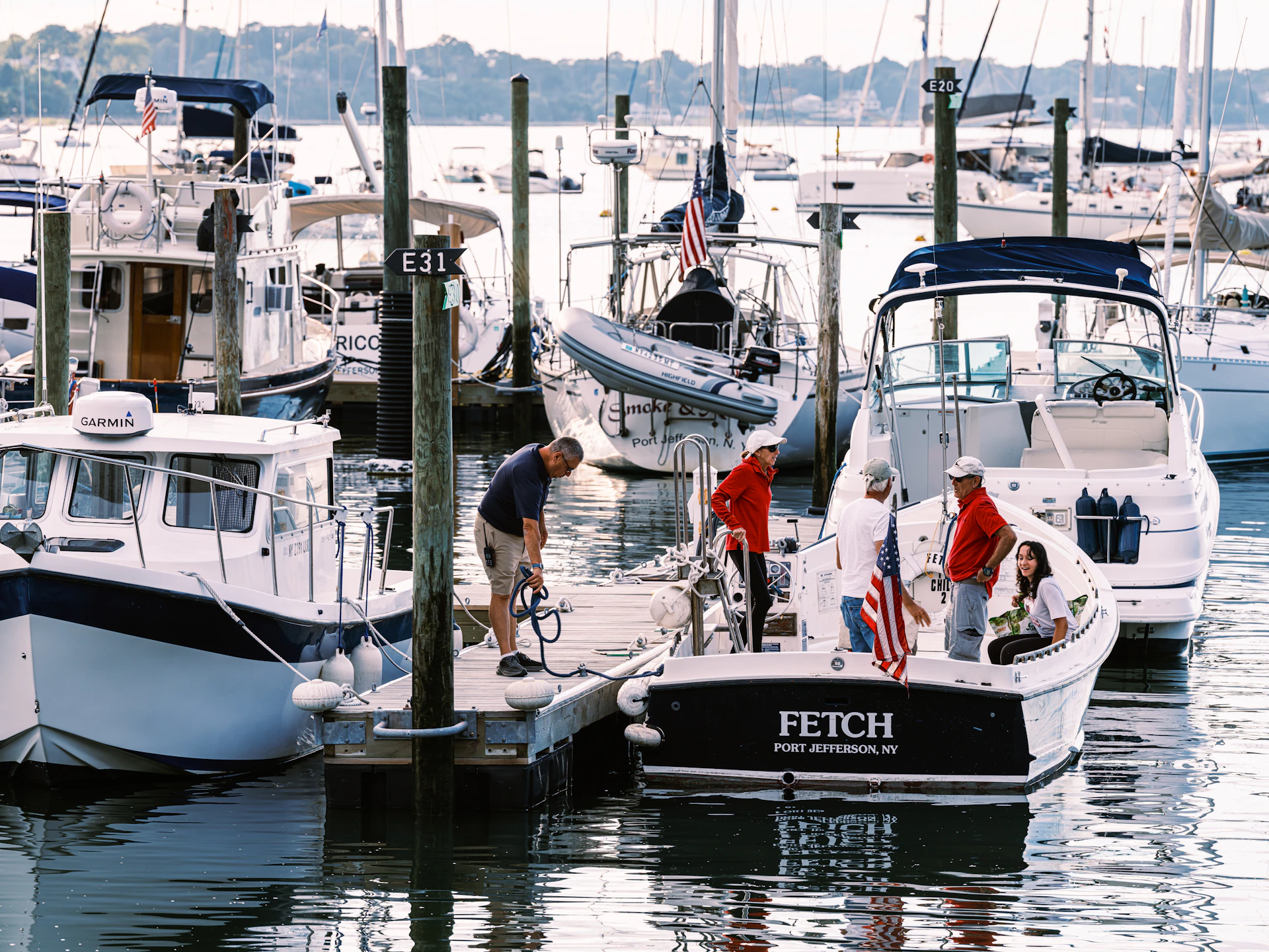 People boarding boats at a marina dock