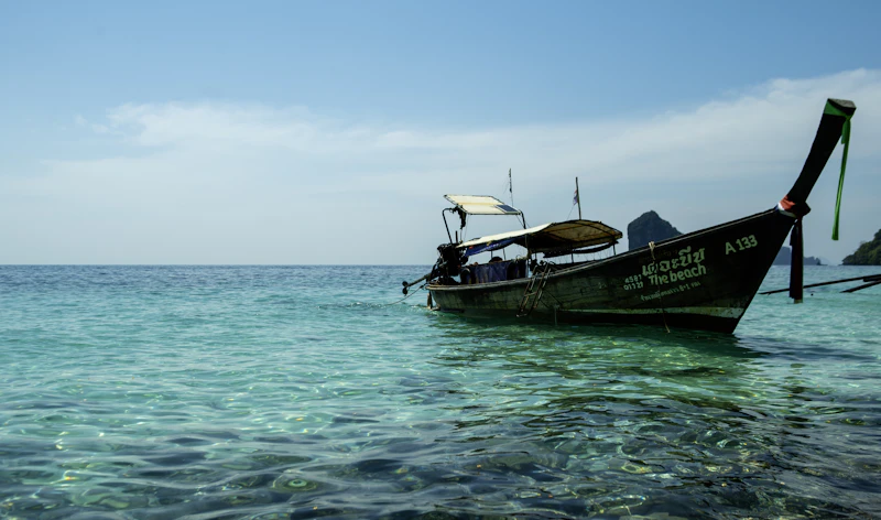 Traditional Thai longtail boat in clear turquoise water
