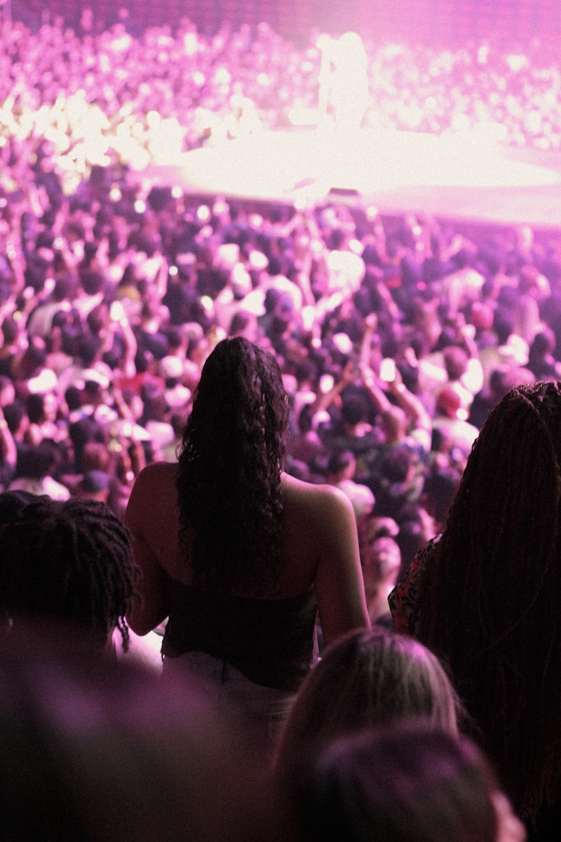 Crowd at a concert with pink lighting