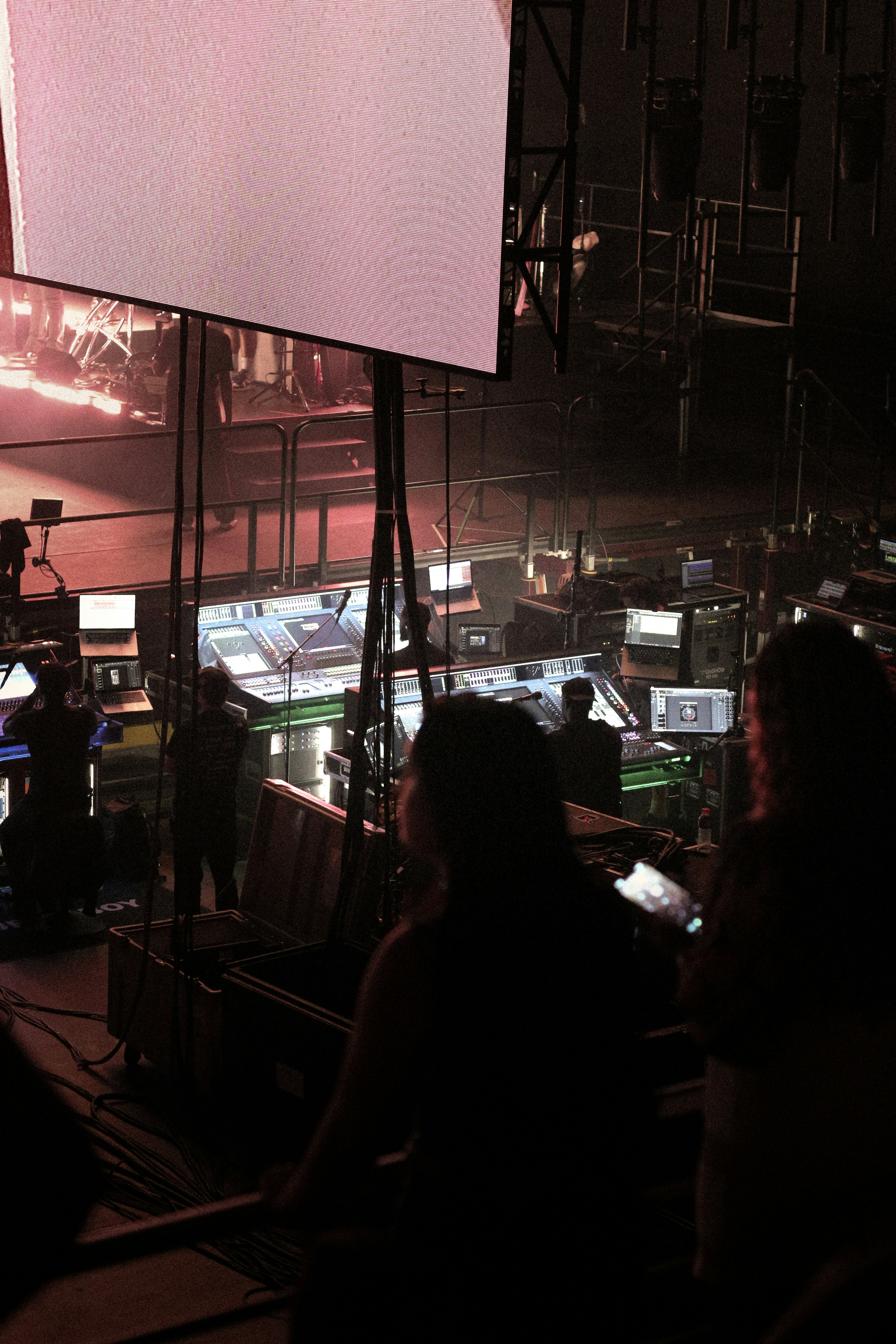 People working at a control desk with screens.