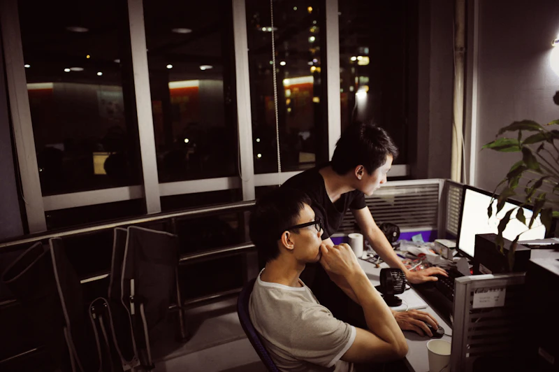 Two people working late in a dark office