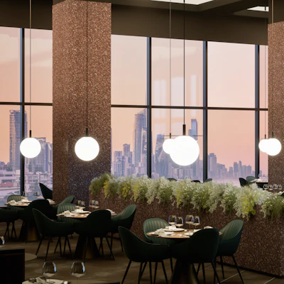 Elegant restaurant interior with city view at sunset.