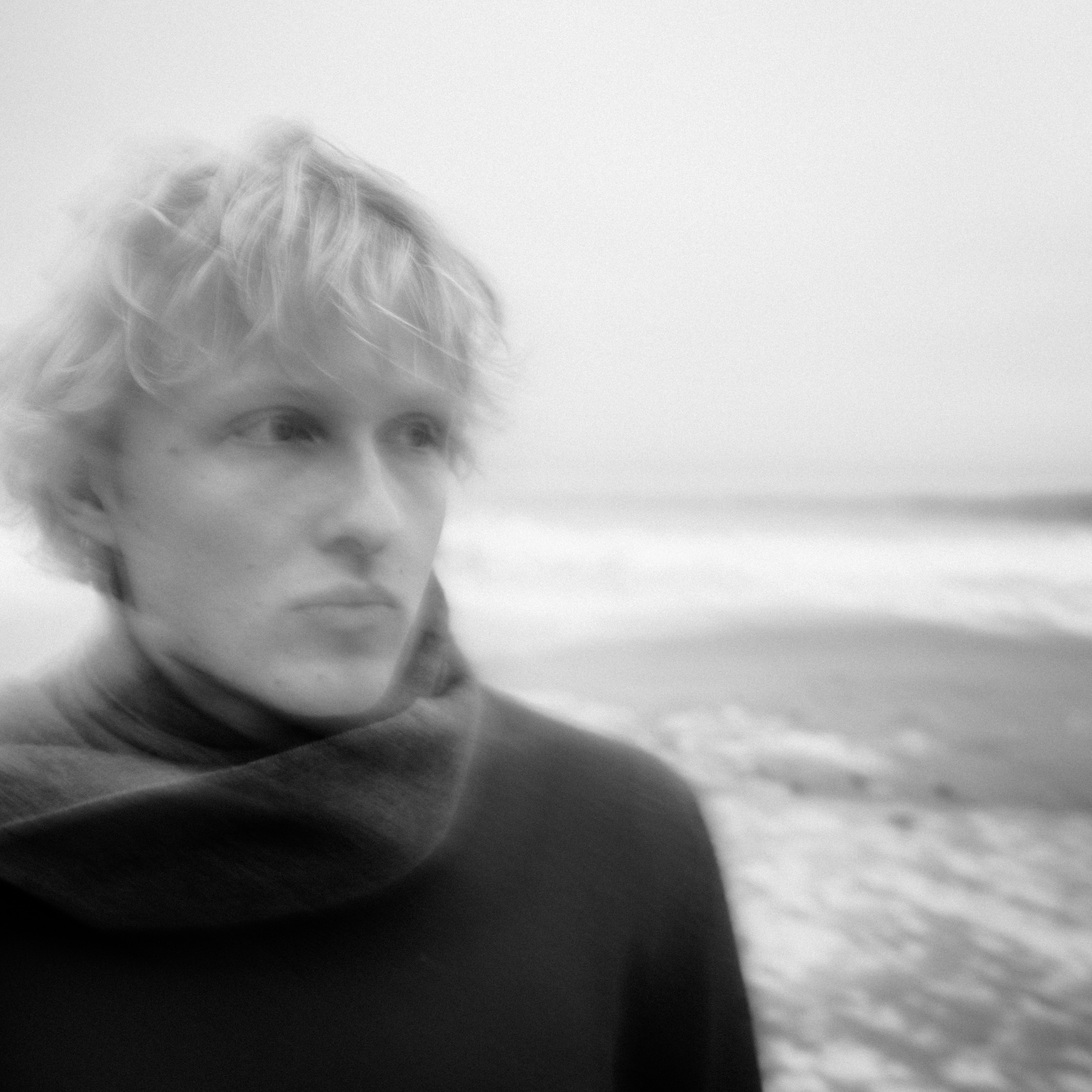 Blonde man with scarf on beach