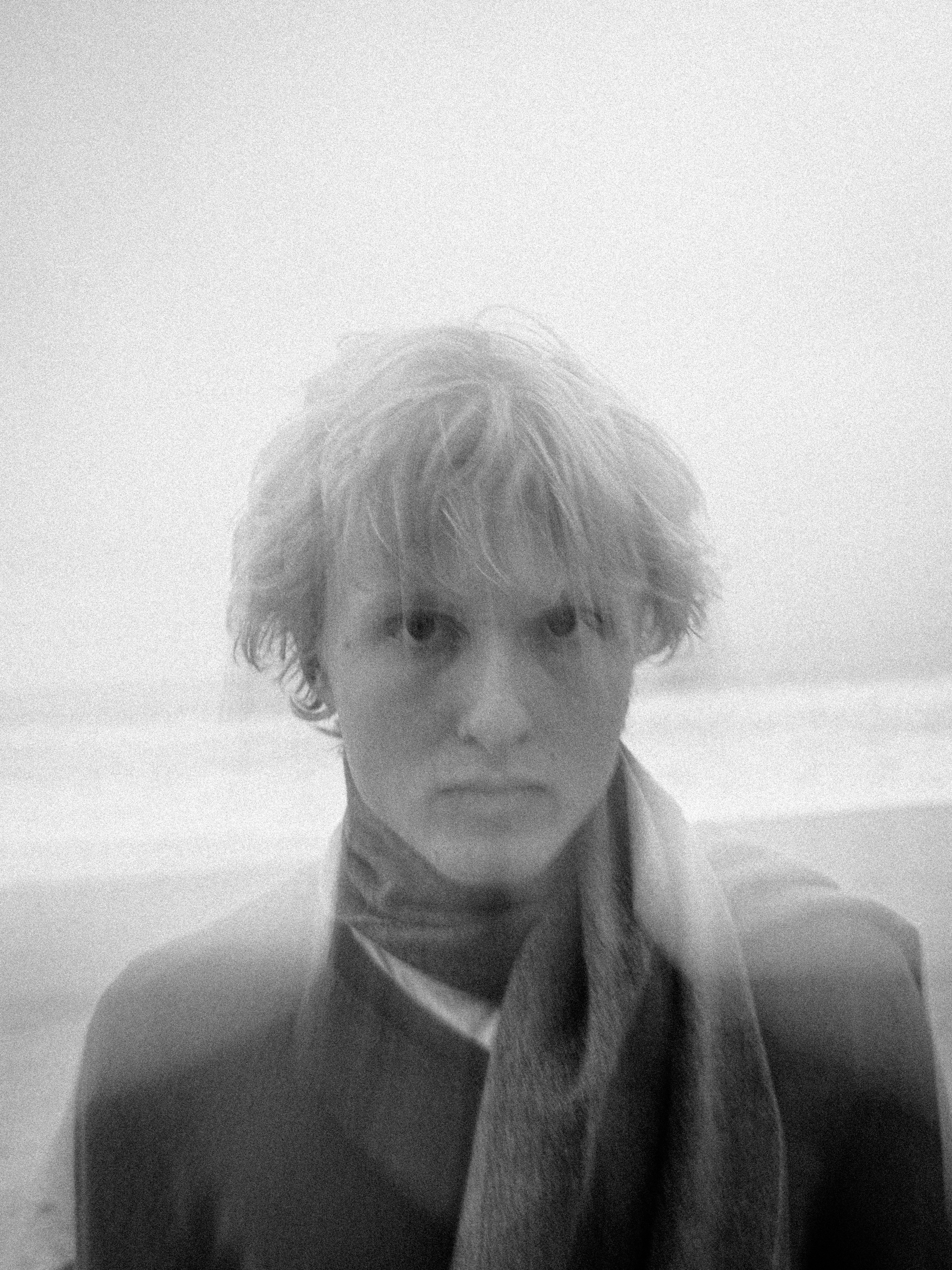 A person with a scarf on the beach