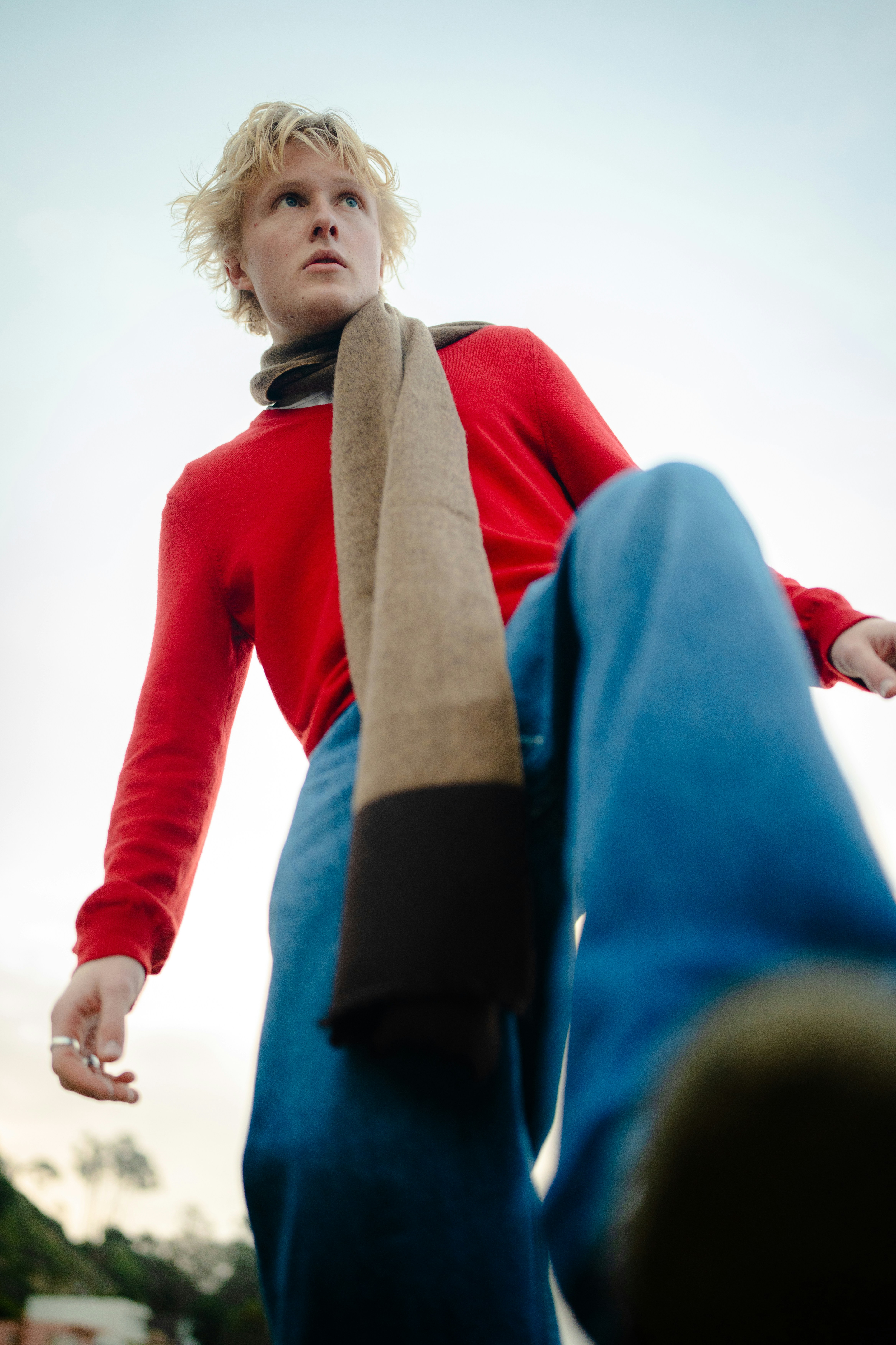 Young man in red sweater and blue jeans