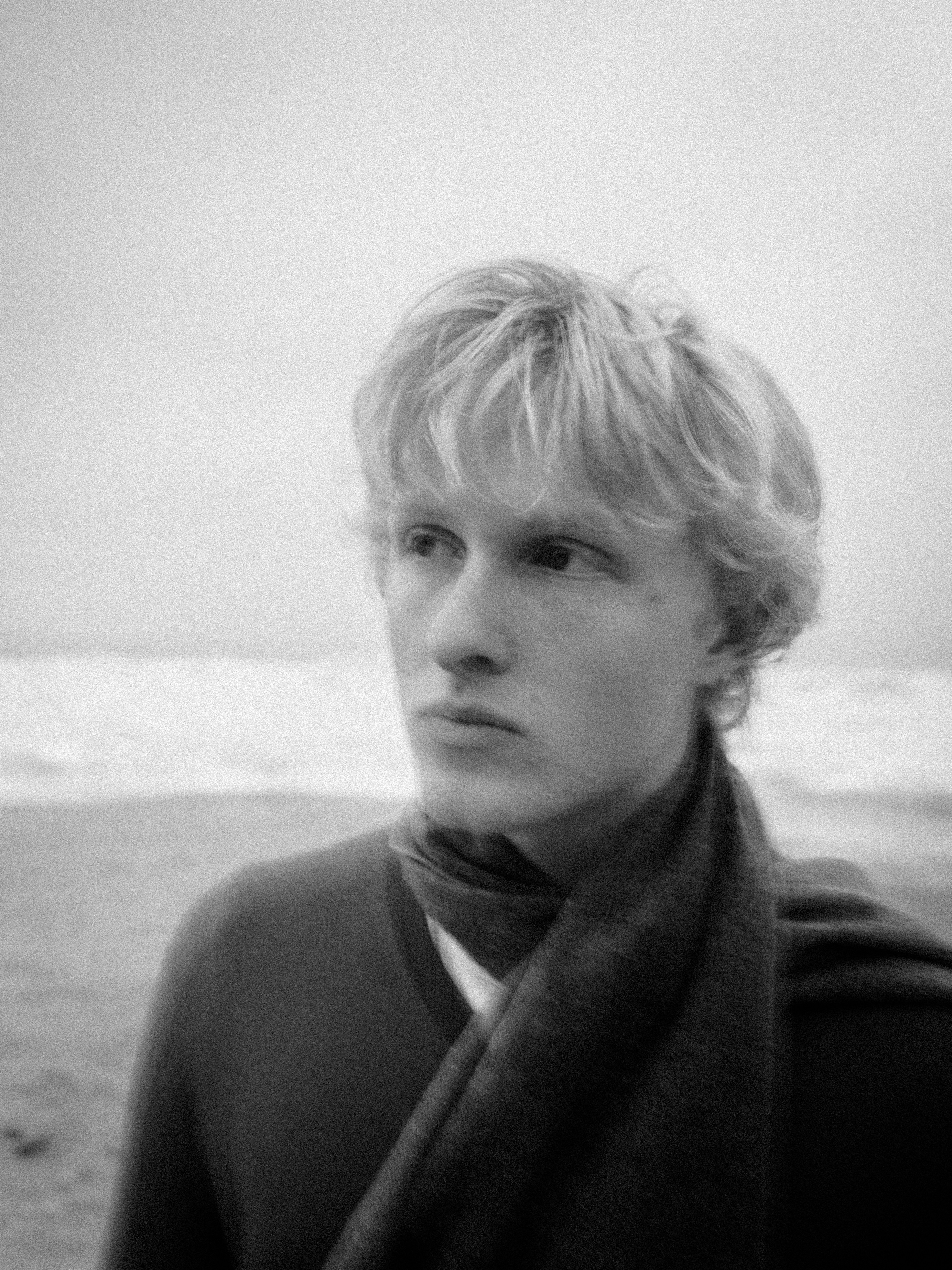 Young man with scarf on beach