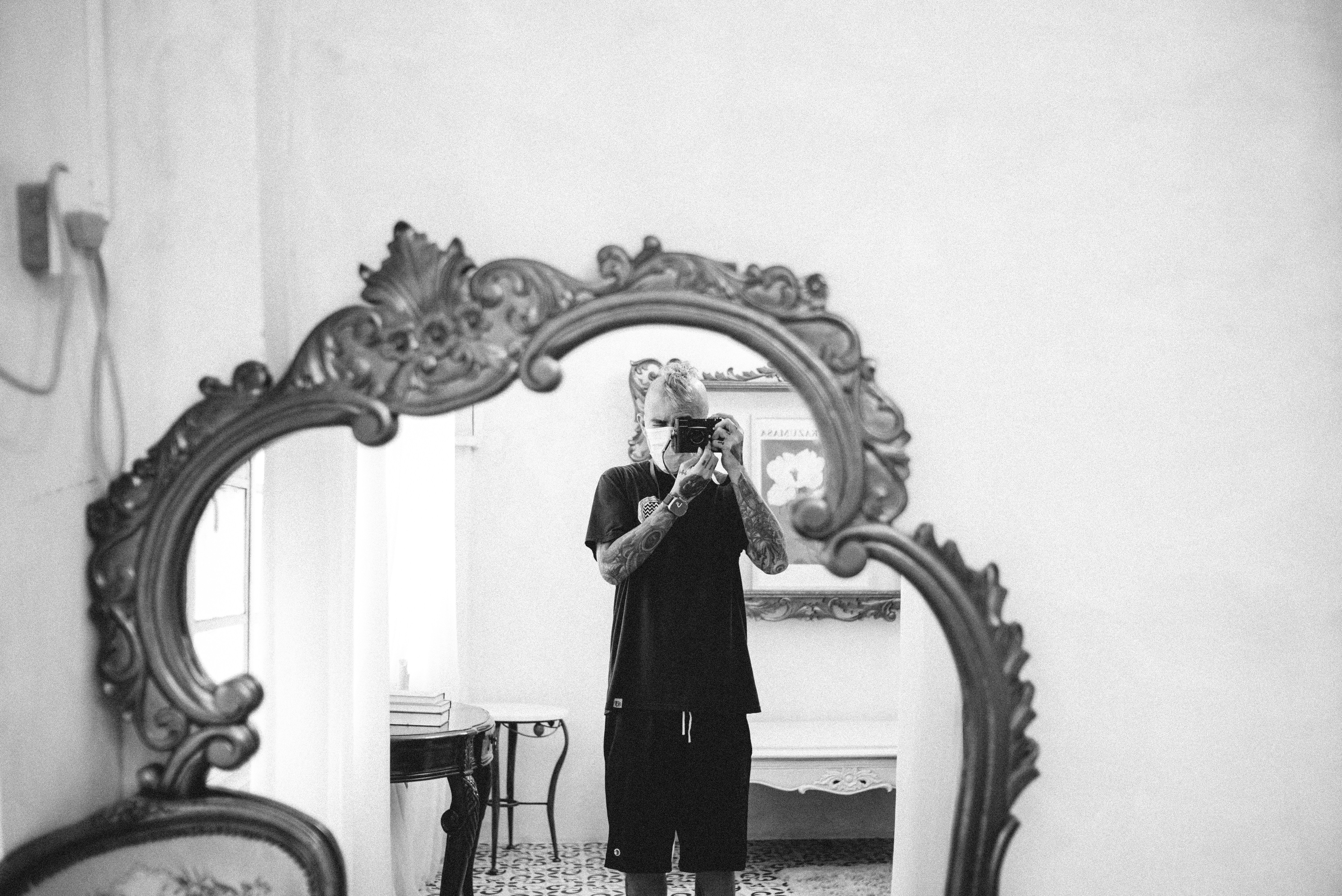 Person taking a selfie in ornate mirror