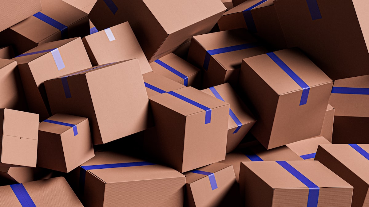 A large pile of brown cardboard boxes in a warehouse