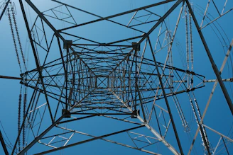 Looking up through a steel power line tower