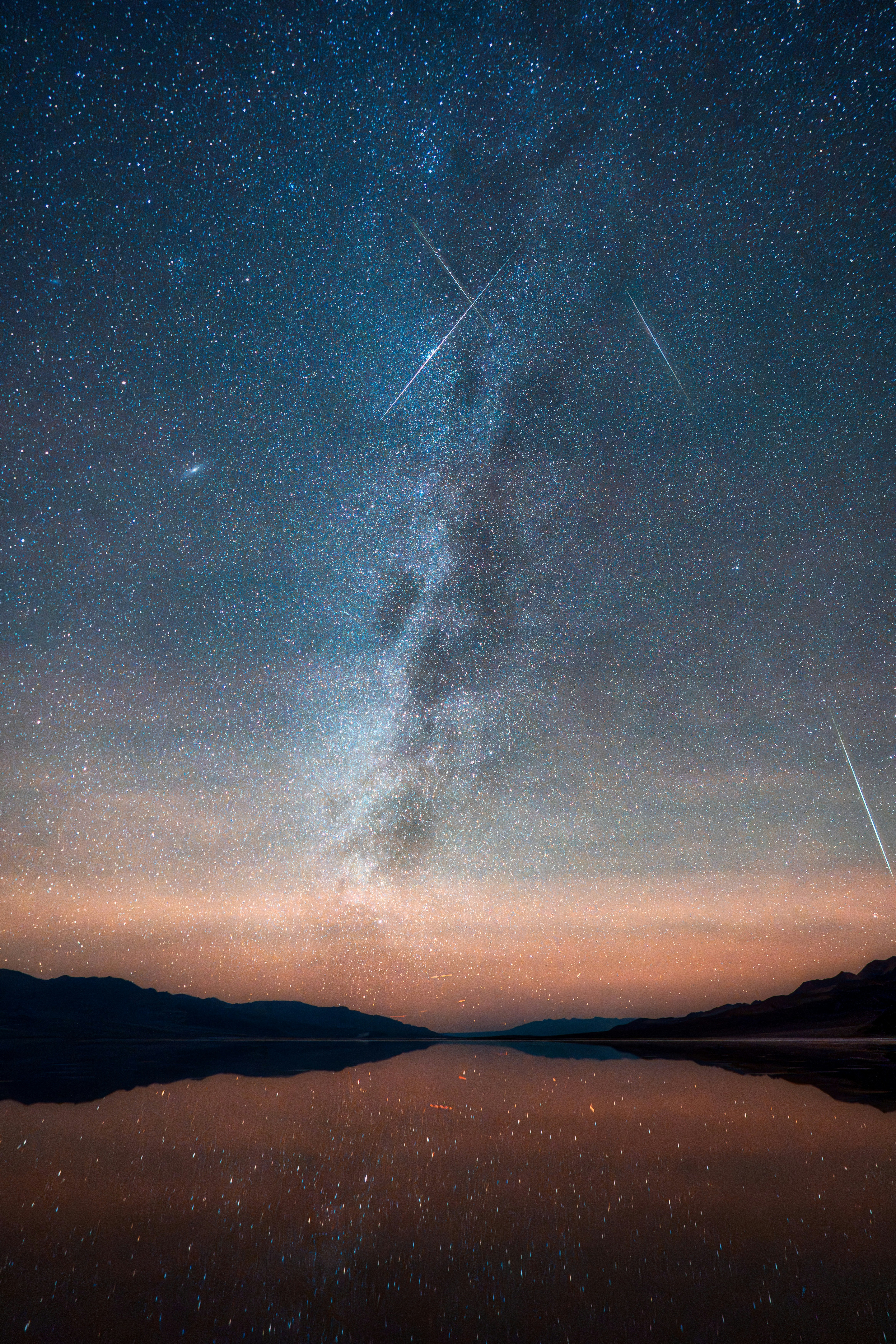 Milky way galaxy over a calm lake at night.